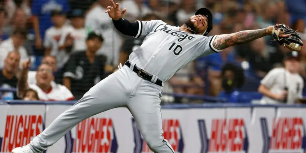 Yoan Moncada makes a quick pick while falling backwards