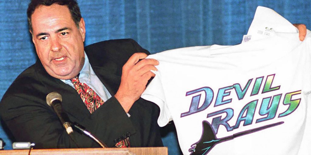 Vince Naimoli holding up the original Devil Rays jersey