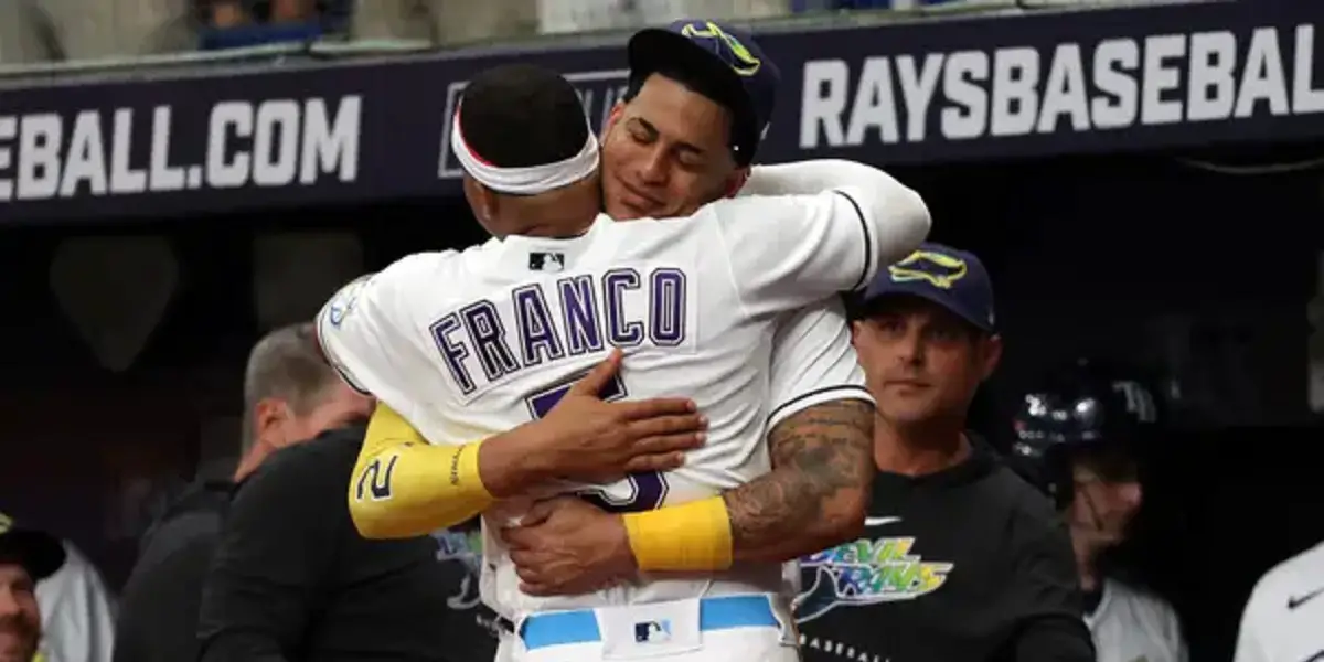 Jose Siri hugs Wander Franco in front of the dugout